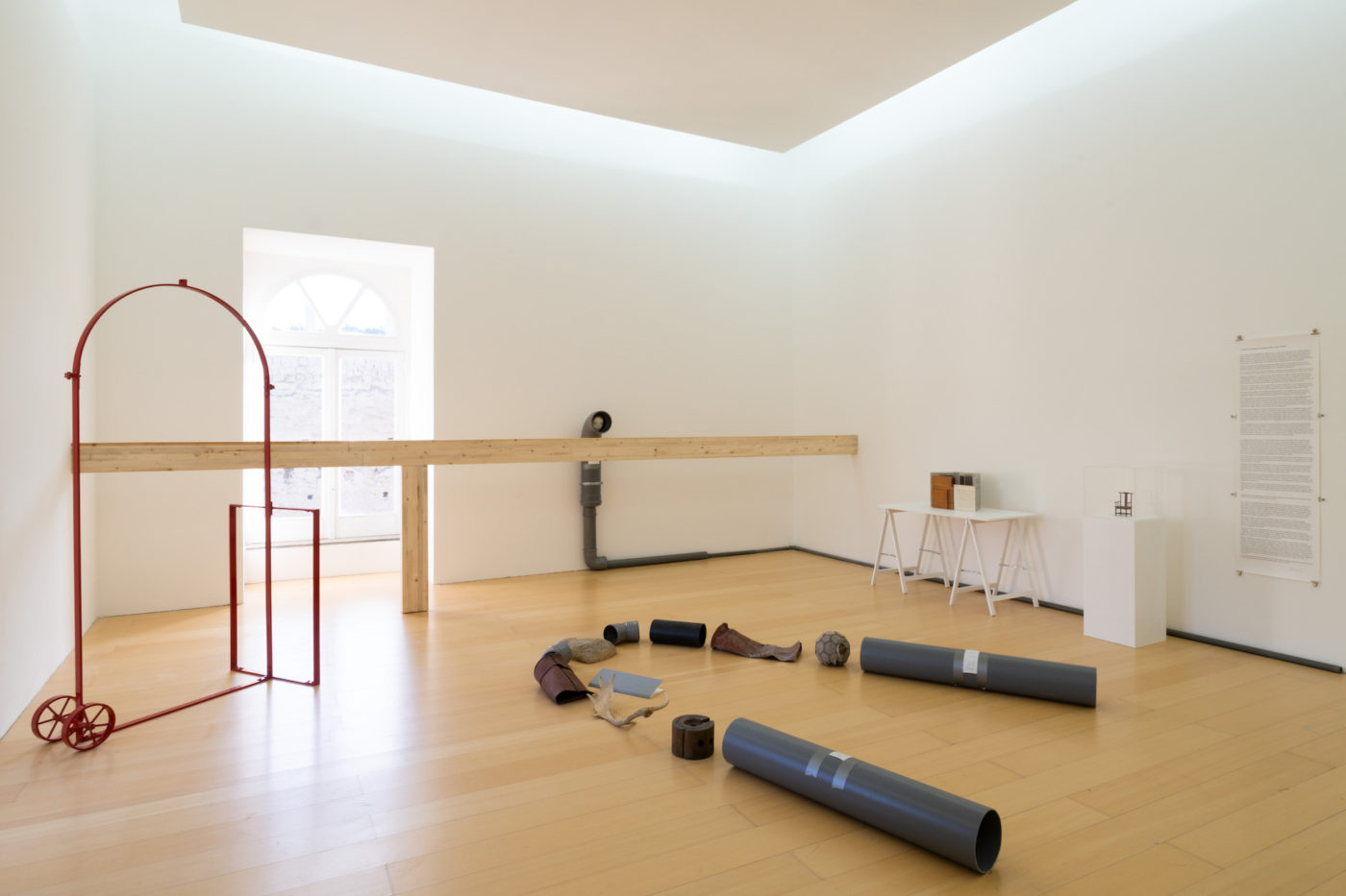 Artwork: odd collection of objects in room : planks, pipes a soccer ball, and metallic structure of unknown origin.jpg